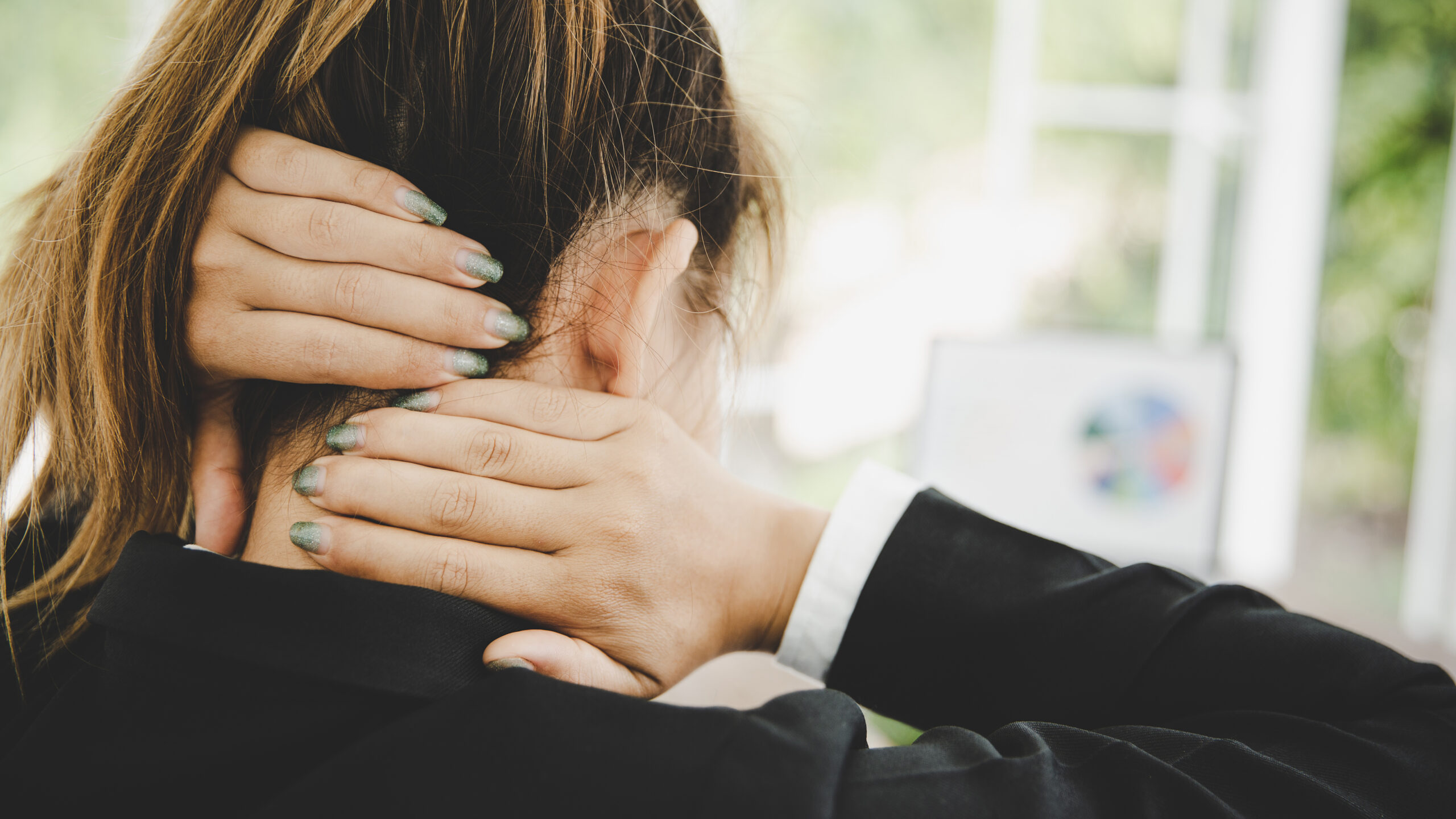 Young asian woman is sitting at work and has pain in her neck Young asian woman is sitting at work and has pain in her neck while she is sitting in the office working