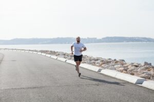 determined-strong-sportsman-running-seaside_1262-6082